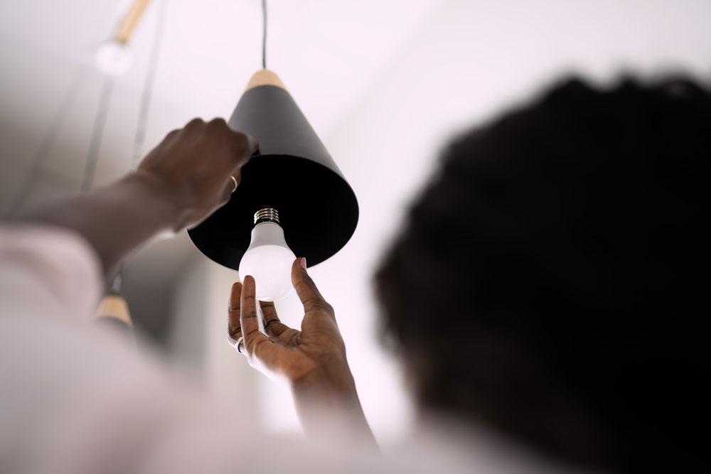 Woman Checking LED Lamp