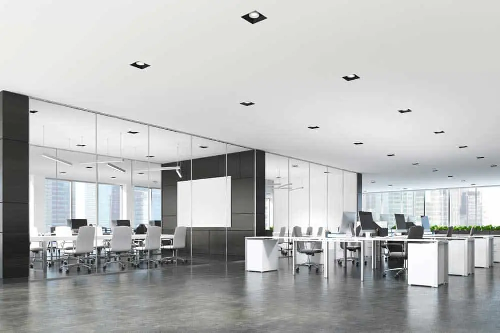  Two conference rooms with glass and dark wooden walls and an open space open office area