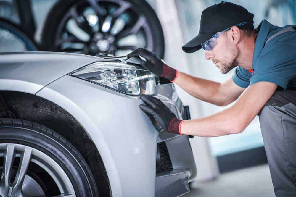 Man checking headlight