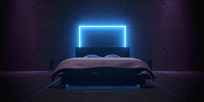 Glowing blue LED light around a bed