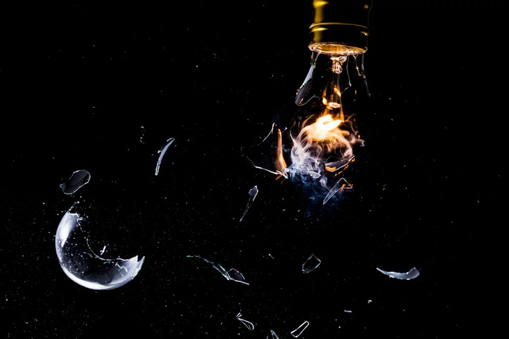 A light bulb shattering while lit