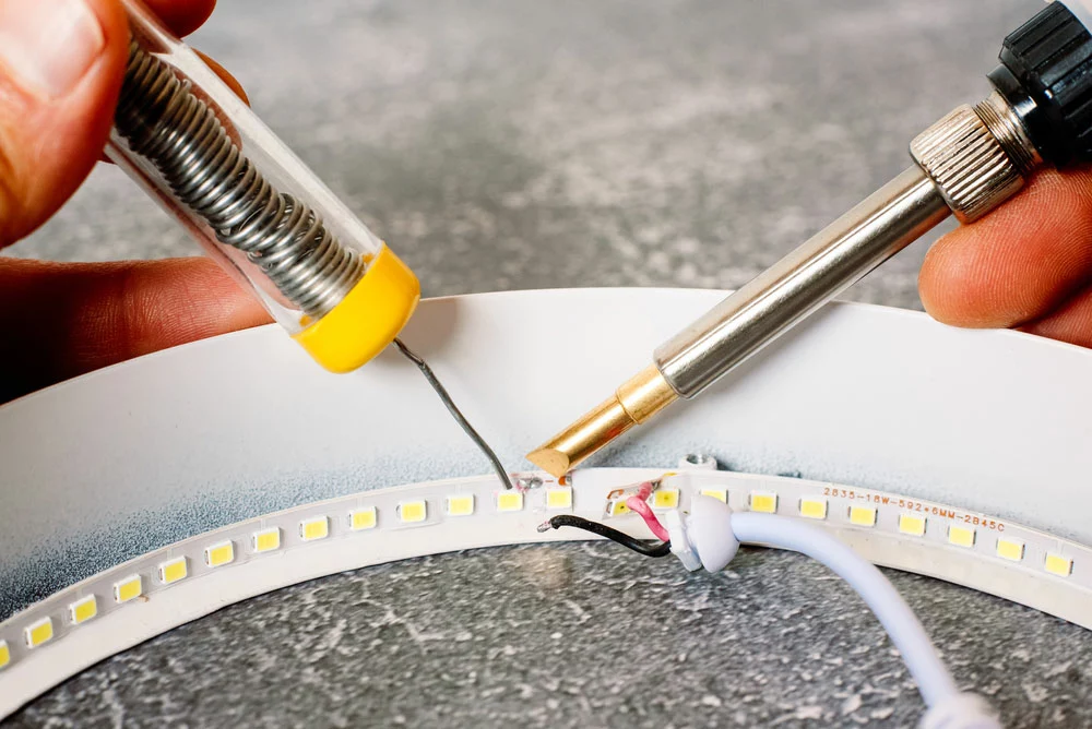 A damaged strip light is being repaired