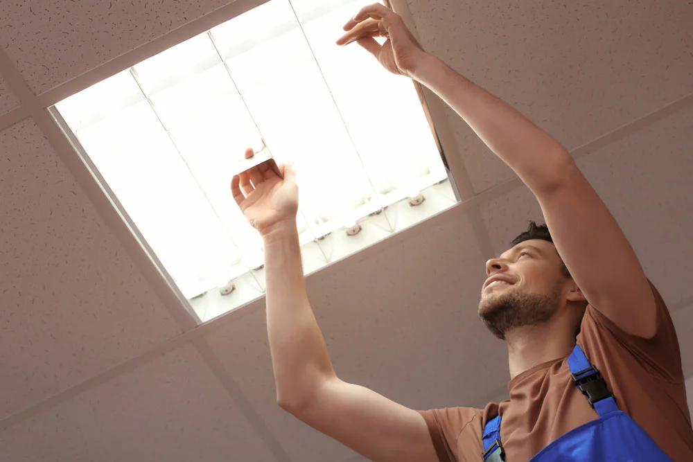 Man changing fluorescent lights