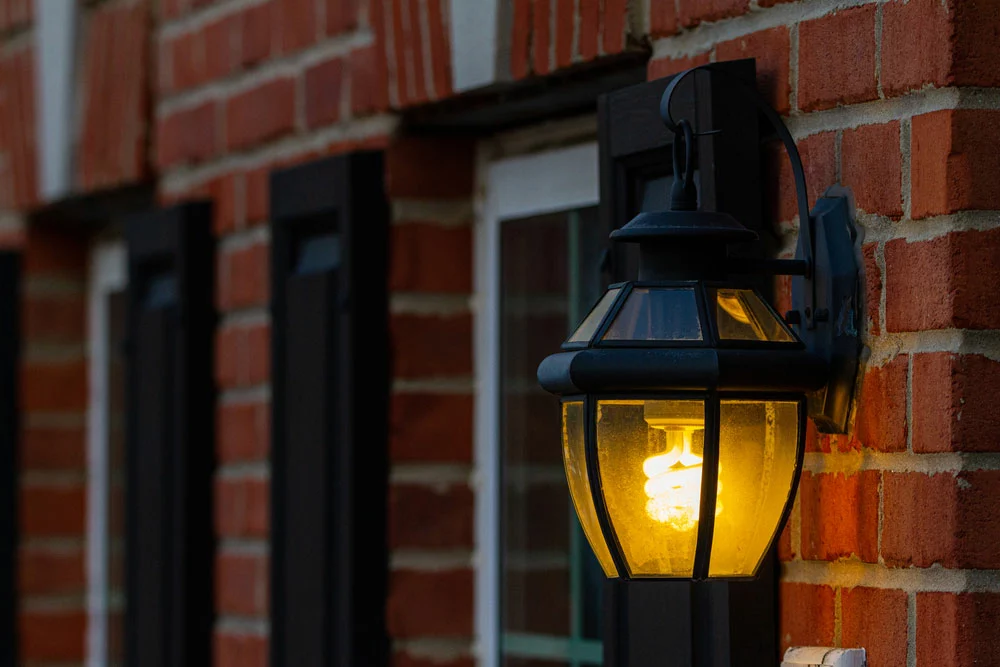 LED Minimum Operating Temperature: A CFL is installed inside a metal wall lantern outdoors