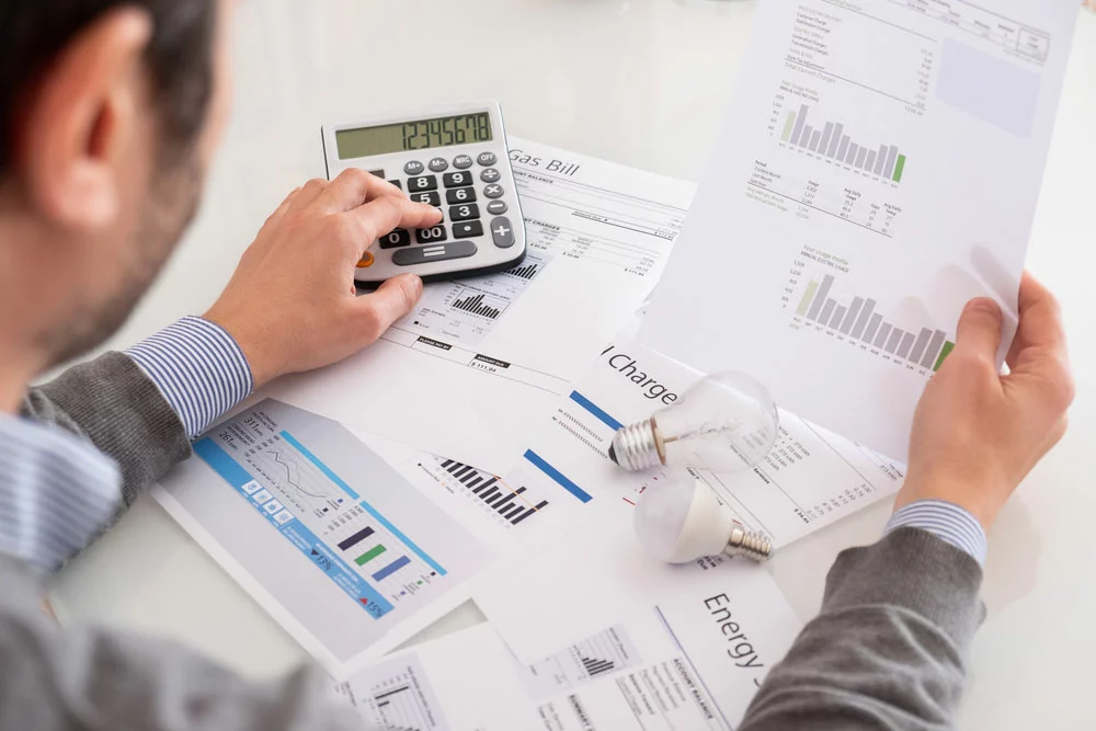 Man calculating gas bill statement and home energy consumption