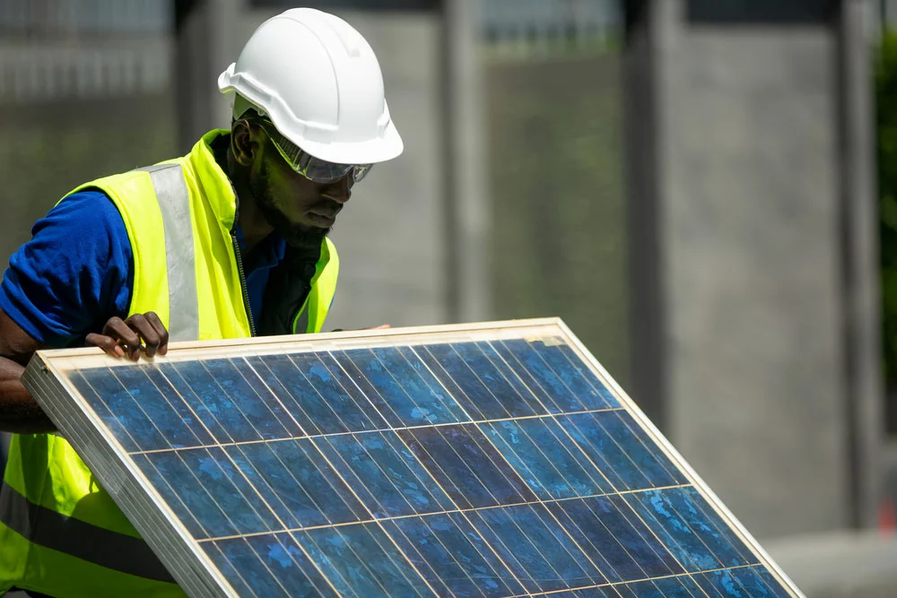 A maintenance engineer inspecting a solar panel