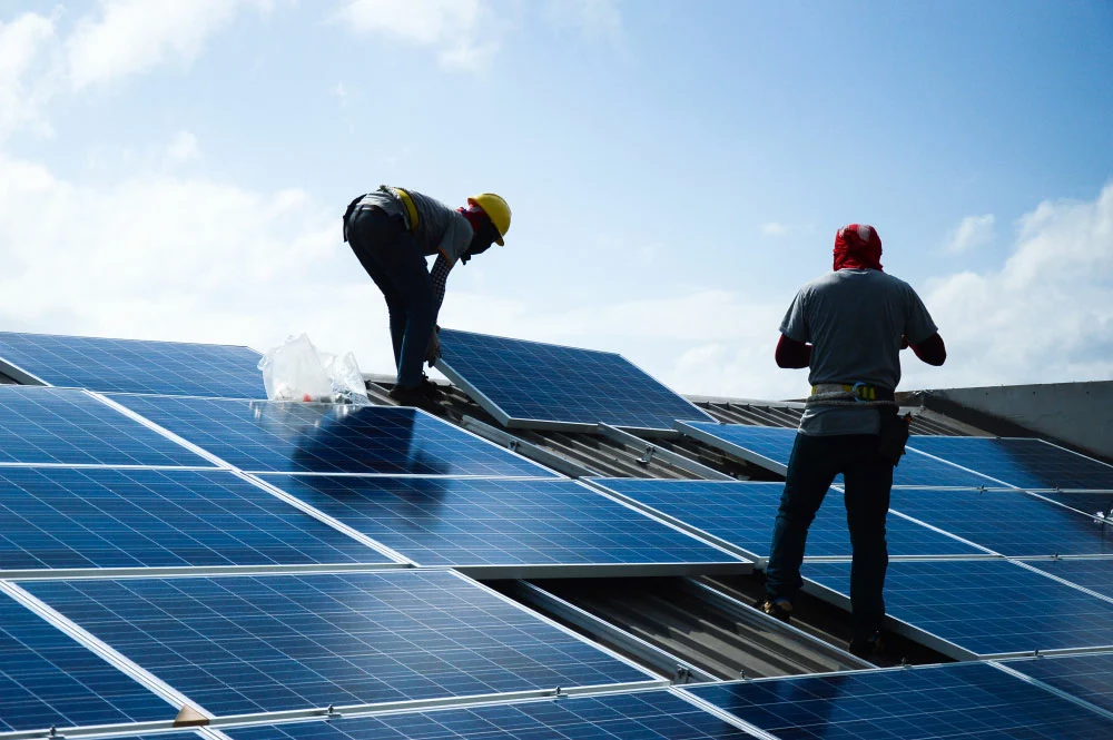Men installing solar panels on a roof