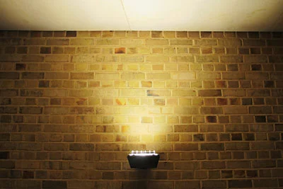 A surface-mounted wall uplight