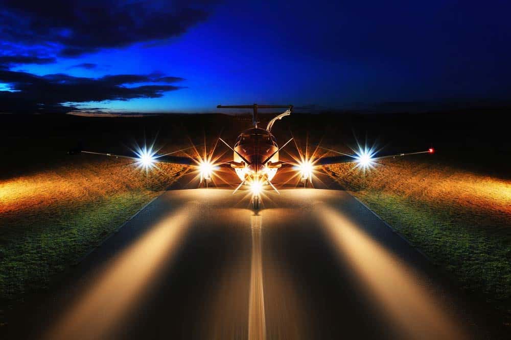 An airplane with all its lights on before takeoff