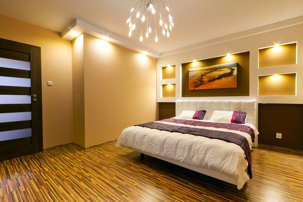 A bedroom with recessed lighting