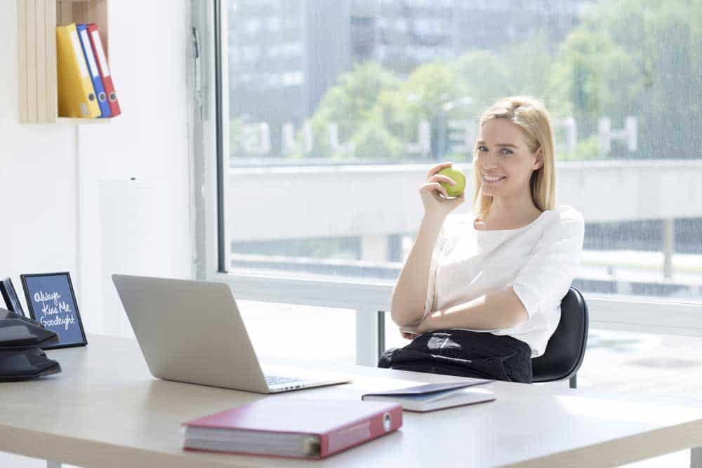 An employee in a good-lit office space. 