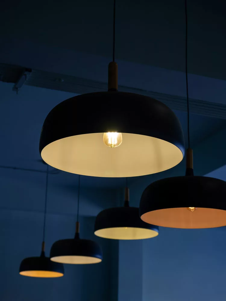 A kitchen with drum pendant lighting