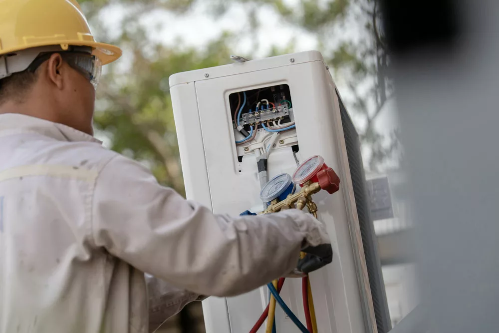 Technician installing a heat pump unit