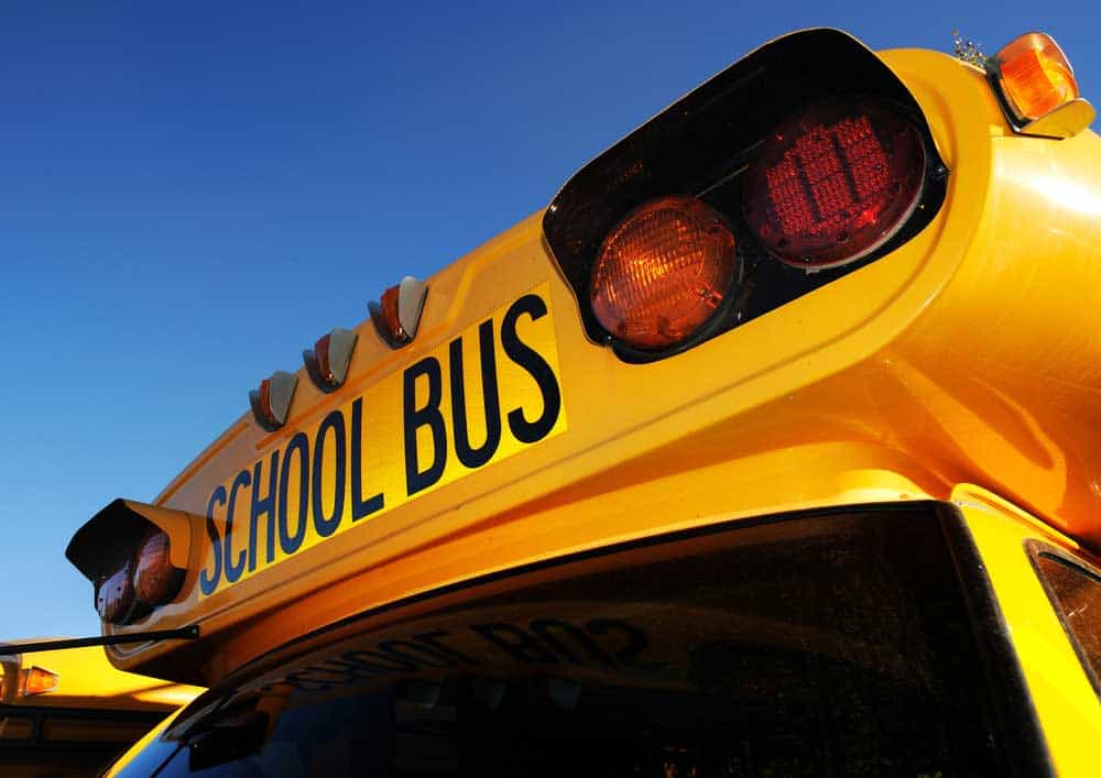 A yellow school bus with marker and clearance lamps. Note the amber side marker light.