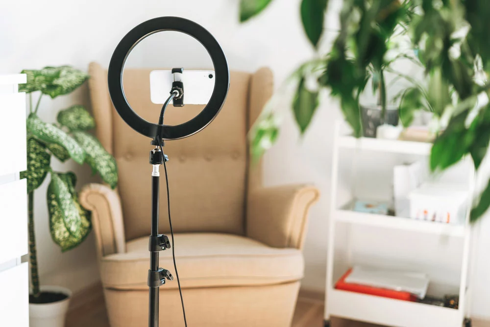 A ring light and mobile phone set up for vlogging or video calling
