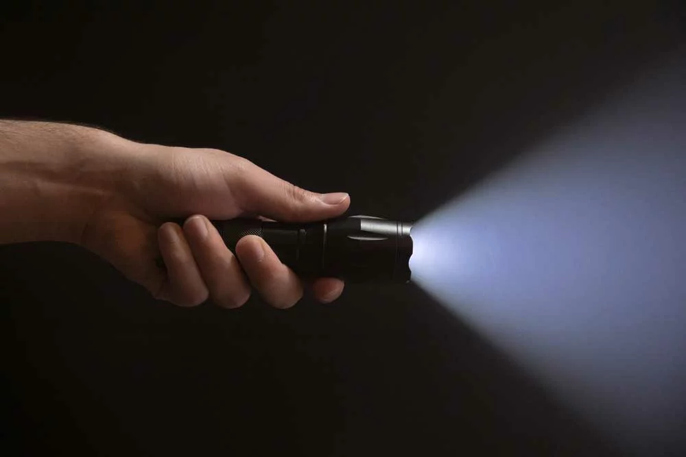 Hand holding flashlight