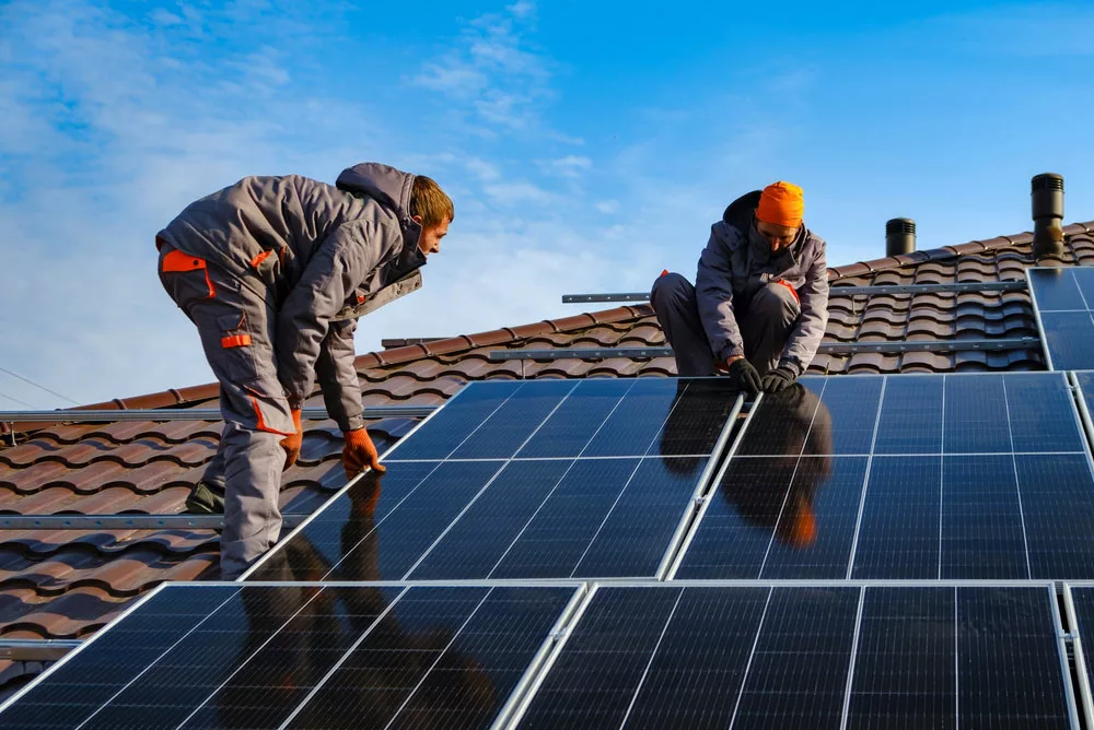 Men installing solar panels on the racking system