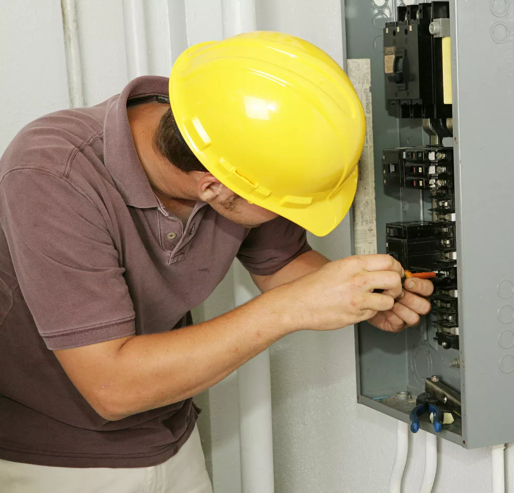 Electrician working on a breaker panel